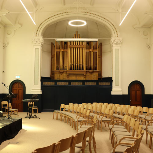 Trinity Hall at The Link Centre with people sitting at tables looking at someone on stage talking about chocolate